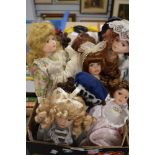 A box full of collectable dolls.