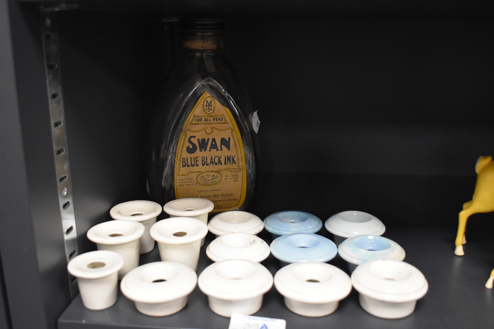 A selection of childrens or similar desk mounted ceramic ink wells and Swan ink bottle