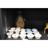 A selection of childrens or similar desk mounted ceramic ink wells and Swan ink bottle