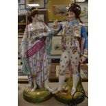 A pair of substantial continental period dressed porcelain figures of renaissance dancers possibly