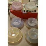 A boxed set of vintage French Arc Opal harlequin tea cup and saucers