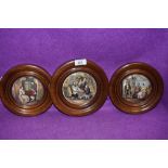 A selection of wooden framed antique pratt ware pot lids