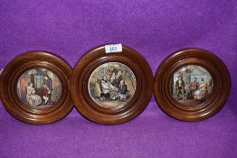 A selection of wooden framed antique pratt ware pot lids