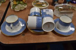 A selection of coffee canisters and saucers by Wedgwood in a blue and gilt design