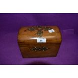 An antique treasure chest design tea caddy having tiger stripped case with brass detailing