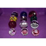 A selection of glass paper weights including Caithness Sirocco and Langham