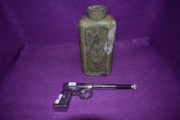 A vintage chromed GAT gun and similar cowboy styled flask