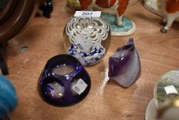 Three art glass paper weights in purple and blue hues