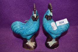 A pair of Chinese blue glaze styled cockerels bearing marks to base