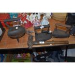 A selection of cast iron items includint two flat stove irons and hammer