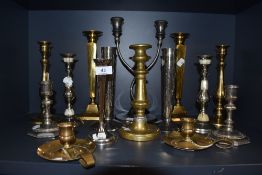 A selection of various candle sticks including brass and plated examples