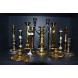 A selection of various candle sticks including brass and plated examples