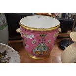 An antique hard paste highly decorated champagne or wine cooler in pink ground with floral