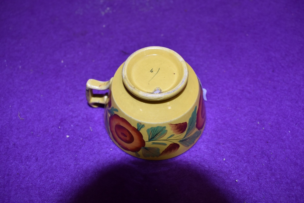 An antique tea cup of small size having hand decoration with mustard yellow glaze and London style - Image 2 of 2