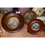 A selection of framed antique pratt ware pot lids