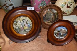 A selection of framed antique pratt ware pot lids