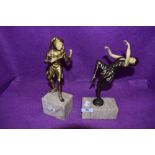 A pair of art deco styled figures styled as two medieval court room performers