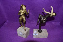 A pair of art deco styled figures styled as two medieval court room performers