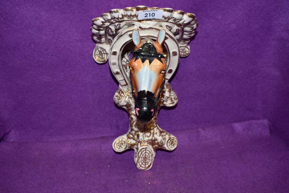 A continental styled wall sconce or bracket in the form of a horse head hand painted and in good