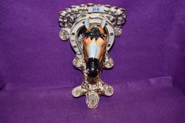 A continental styled wall sconce or bracket in the form of a horse head hand painted and in good