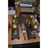 A pair of Victorian fire dogs with brass fitments and similar carved oak belows
