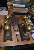 A pair of Victorian fire dogs with brass fitments and similar carved oak belows