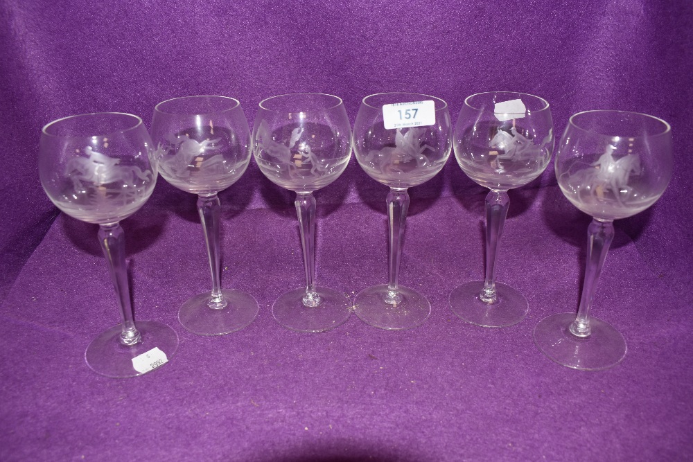 A set of six wine glasses having individual etched scenes of horse riding or racing