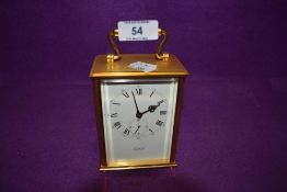 A brass cased carriage clock by HOF Switzerland