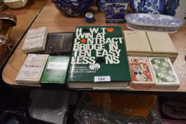 A selection of playing cards and Bridge related text book