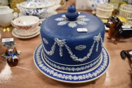 An antique Jasperware styled blue and white wear cheese dome and lid