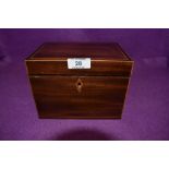 An antique tea caddy having mahogany case with inlayed detailing and foiled compartments