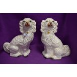 A pair of antique Staffordshire flat back mantle spaniel dogs 33cm tall