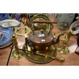 A selection of fireside items including copper stove kettle trivets and candle sticks