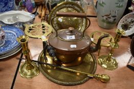 A selection of fireside items including copper stove kettle trivets and candle sticks