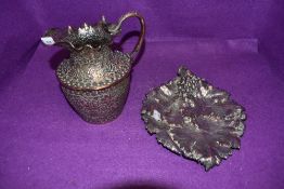 Two fine metal wares an Indian cobra handle water jug and similar vine leaf bon bon dish