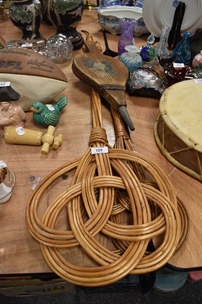 A selection of carpet beaters and similar fire side bellows