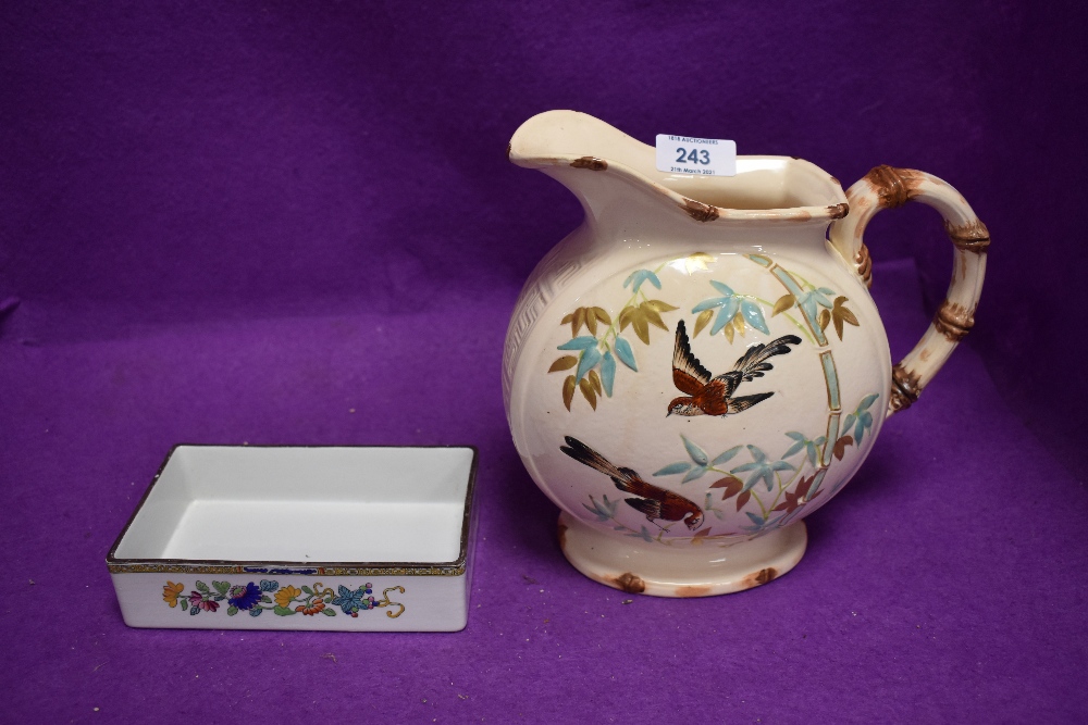 An early Copeland water jug decorated with garden birds and similar later Copeland Spode dish