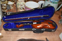 A modern musical violin in hard bodied case