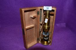 An antique scientific field microscope lebeled A Franks