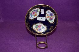 An antique pin dish having cobolt blue gold and hand decorated floral scenes bearing crossed