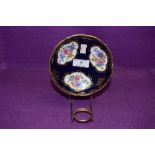 An antique pin dish having cobolt blue gold and hand decorated floral scenes bearing crossed