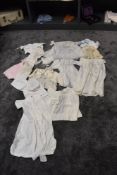 A varied lot of childrens/ babies clothing, some knitted others cotton with delicate detailing