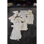 A varied lot of childrens/ babies clothing, some knitted others cotton with delicate detailing