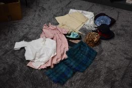 A mixed lot of vintage clothing and accessories including shawls and hats.