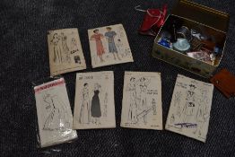 A tin of haberdashery and six 1930s and 40s patterns including nightwear, lingerie and dresses.
