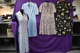 Four vintage dresses including bright floral 1970s London pride dress with tags still attached.