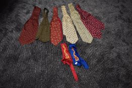 A variety of vintage cravats and two Chinese ties having embroidered dragons.