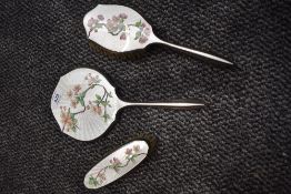 A mid century silver plated dressing table set having enamel guilloche backs over painted with