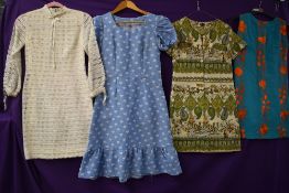 Four vintage dresses having bright patterns in a variety of fabrics and styles,small and medium