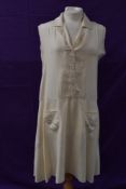 A cream silk 1920s day dress having button front and dropped waist with embroidered floral details